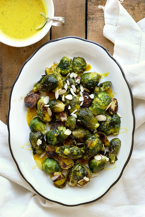 Pan Roasted Brussels Sprouts with Lemon Green Tahini and Honey Drizzle